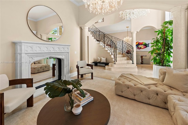 living room featuring a fireplace, ornamental molding, and ornate columns