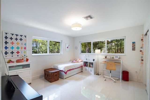 tiled bedroom featuring multiple windows