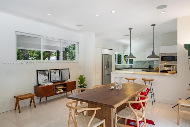 dining space featuring light tile patterned floors