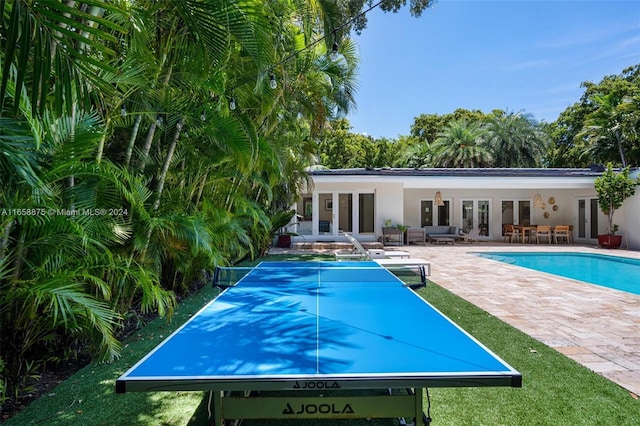 view of pool with a patio area and french doors