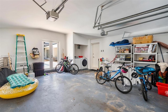 garage featuring french doors, separate washer and dryer, and a garage door opener