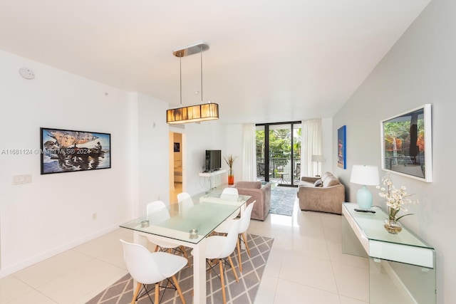 dining space featuring vaulted ceiling and light tile patterned floors