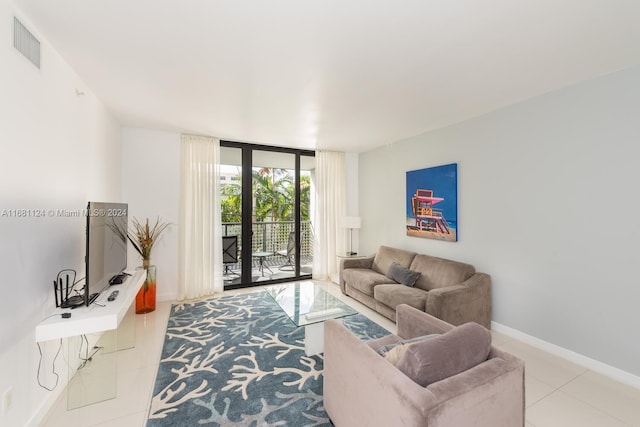 tiled living room with floor to ceiling windows