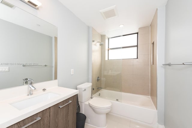 full bathroom featuring toilet, tiled shower / bath combo, vanity, and tile patterned floors