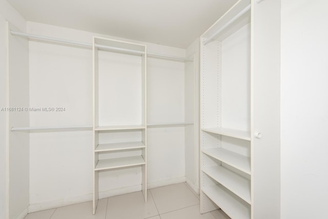 walk in closet with light tile patterned floors