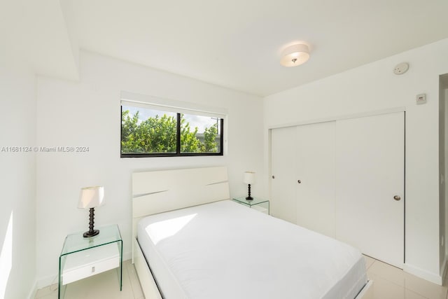 bedroom featuring a closet and light tile patterned flooring