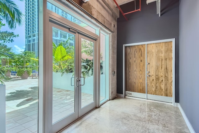 doorway to outside with concrete floors and french doors