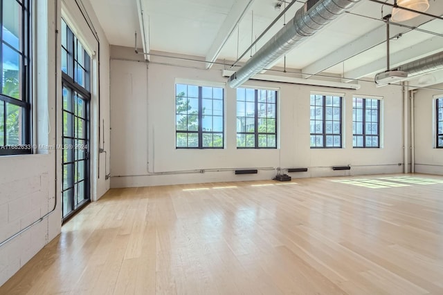 unfurnished room with basketball court and light wood-type flooring