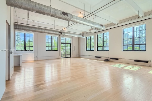 unfurnished room with a wealth of natural light and light wood-type flooring