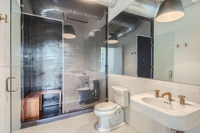 bathroom with sink, tile patterned flooring, toilet, decorative backsplash, and tile walls