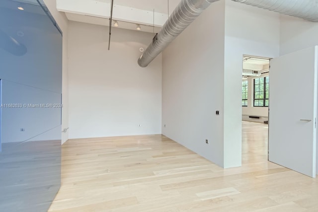 unfurnished room with light hardwood / wood-style floors