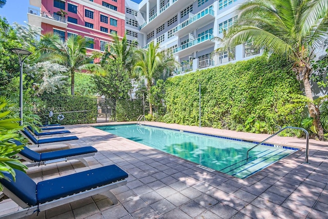 view of swimming pool featuring a patio area