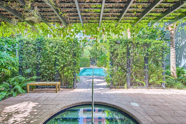 view of pool featuring an in ground hot tub, a pergola, and a patio area