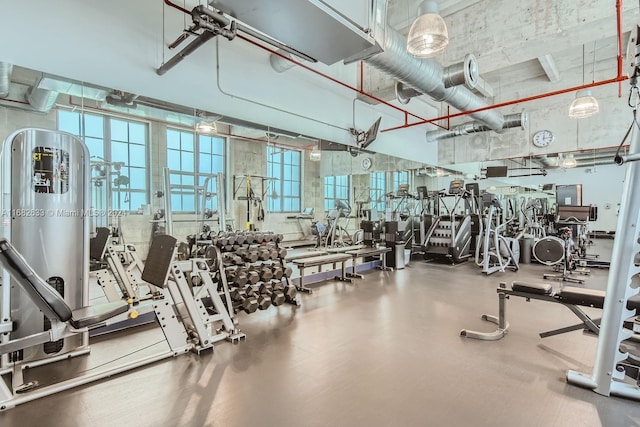 gym featuring a towering ceiling