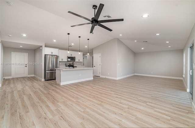 unfurnished living room with vaulted ceiling, light hardwood / wood-style floors, and ceiling fan