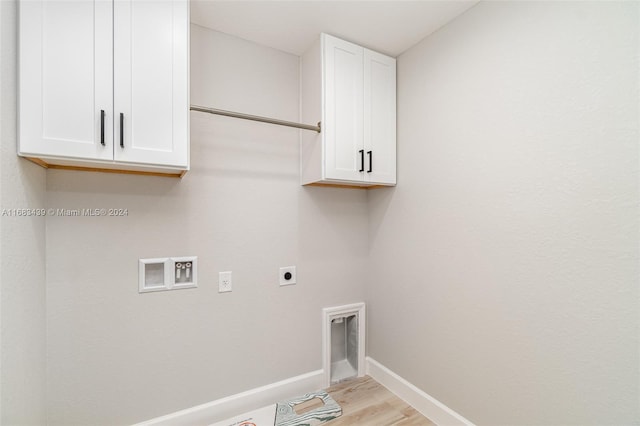 washroom featuring cabinets, washer hookup, light hardwood / wood-style floors, and electric dryer hookup