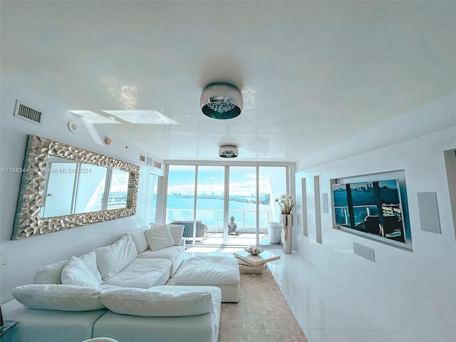 living room featuring light tile patterned flooring and plenty of natural light