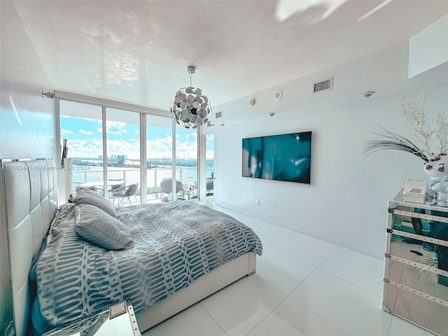 2020 N Bayshore Dr Unit 2007, Miami, FL 33137 - tiled bedroom featuring an inviting chandelier, visible vents, and a wall of windows