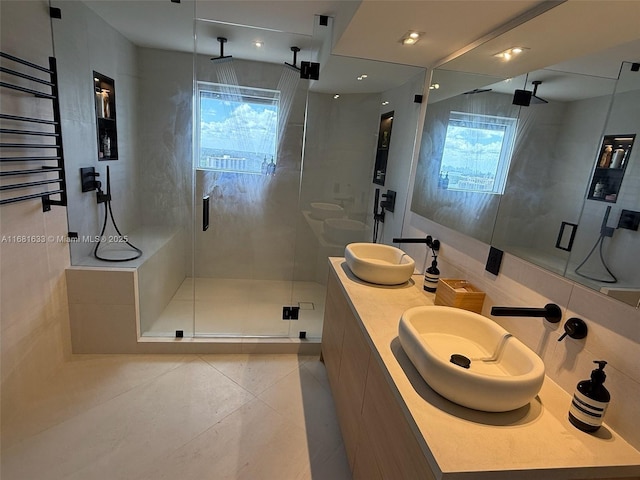 bathroom with tile patterned floors, vanity, a healthy amount of sunlight, and an enclosed shower