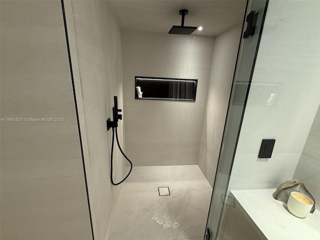 bathroom with a shower with door