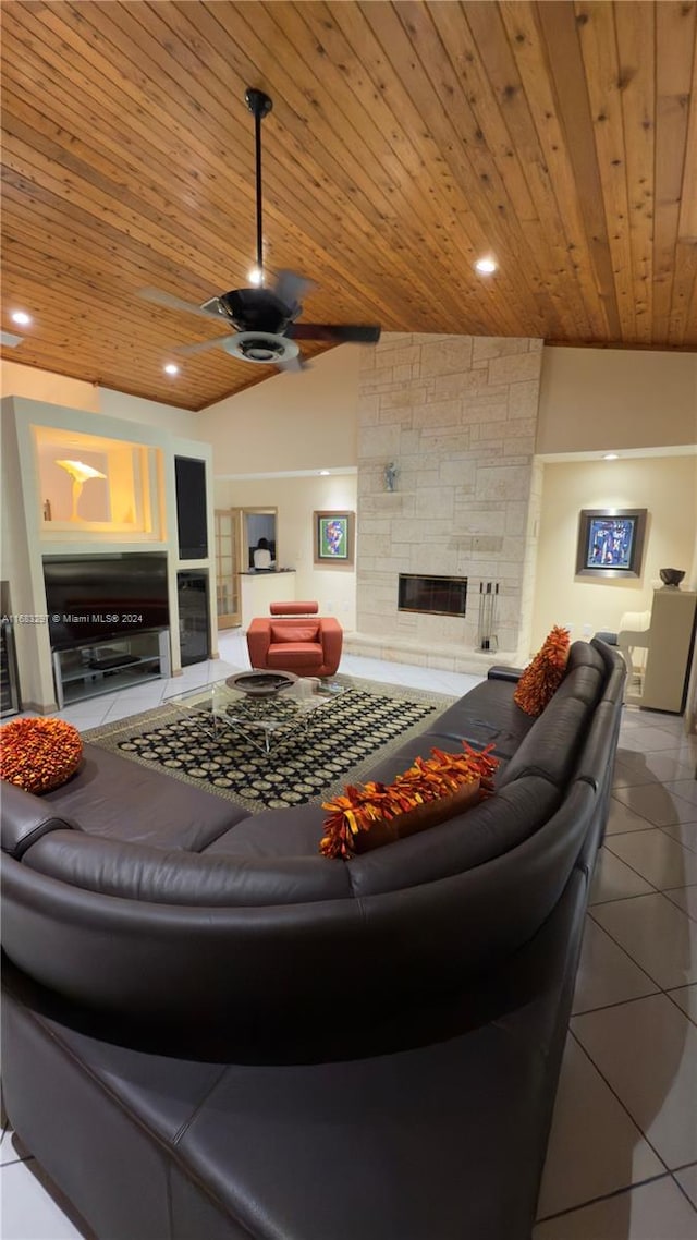 living room featuring wood ceiling, tile patterned flooring, ceiling fan, and vaulted ceiling