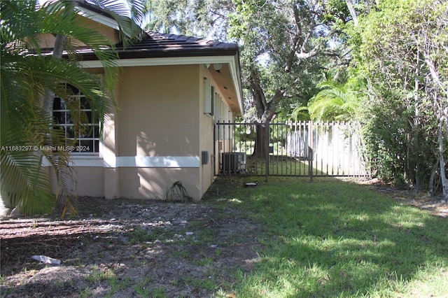 view of home's exterior featuring central AC and a lawn