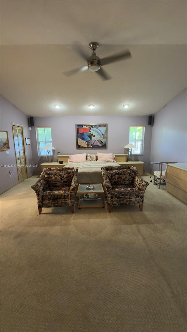 carpeted living room featuring ceiling fan and plenty of natural light