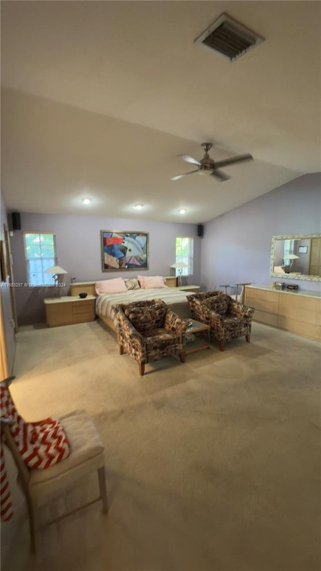 carpeted bedroom with vaulted ceiling and ceiling fan