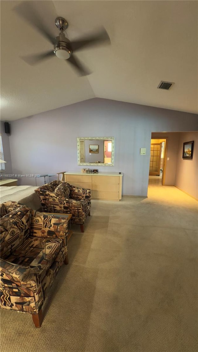 living room with ceiling fan, carpet, and vaulted ceiling