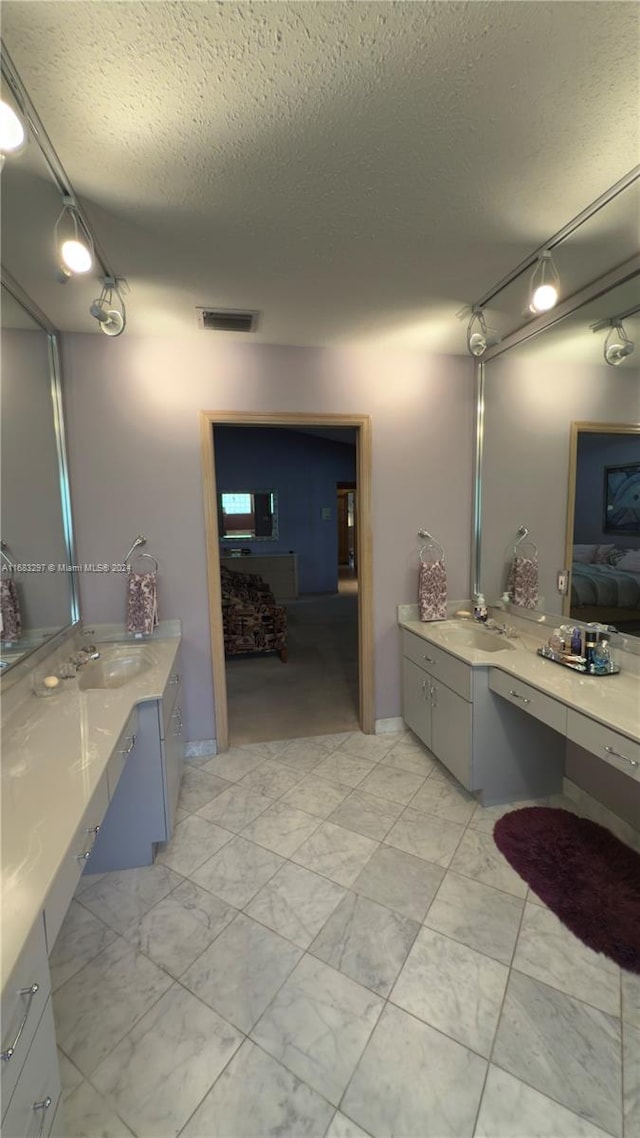 bathroom with vanity and a textured ceiling