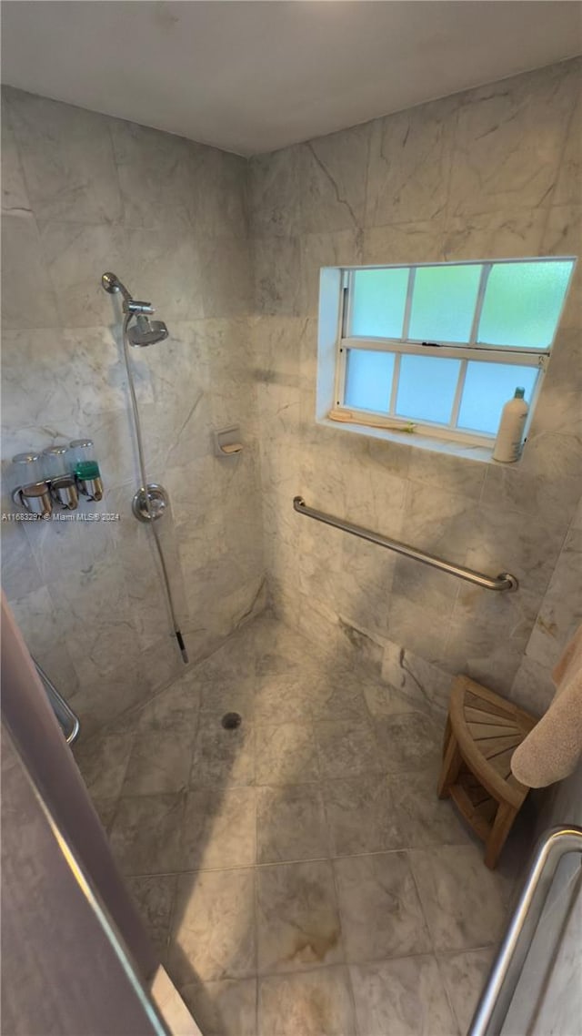 bathroom with a tile shower