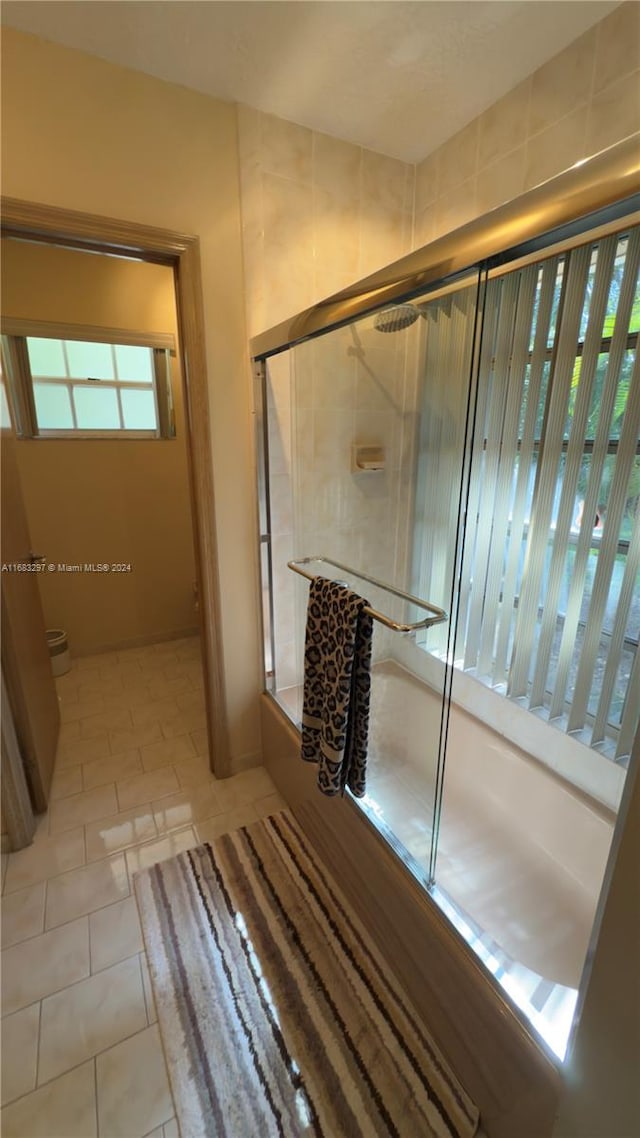 bathroom featuring toilet, walk in shower, and tile patterned flooring