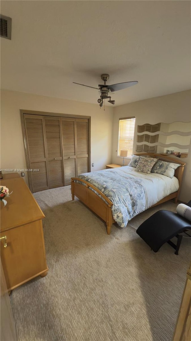 carpeted bedroom with a closet and ceiling fan