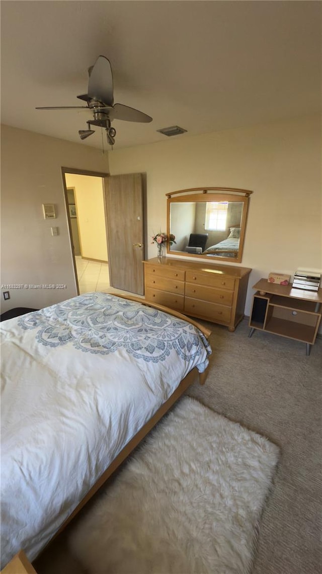 bedroom featuring light carpet and ceiling fan