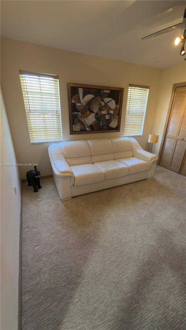 unfurnished living room with carpet flooring and ceiling fan