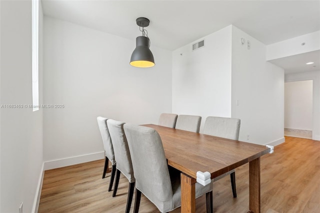 dining area featuring light wood-type flooring