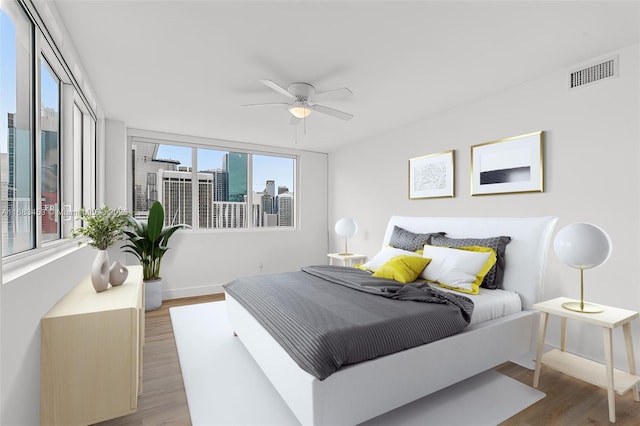 bedroom with ceiling fan and hardwood / wood-style floors