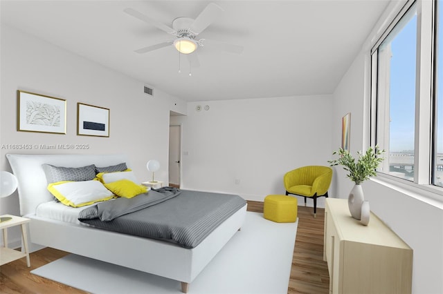 bedroom with ceiling fan and hardwood / wood-style floors