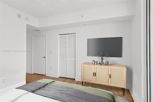 bedroom with a closet and hardwood / wood-style flooring