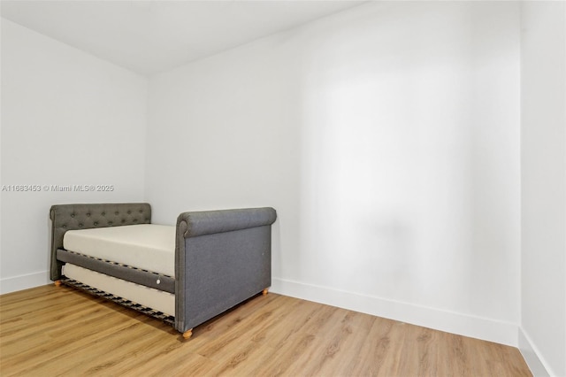 sitting room with wood-type flooring