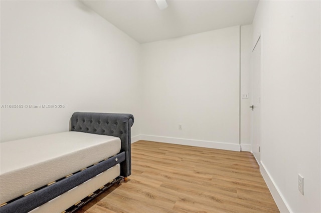 bedroom with hardwood / wood-style floors and ceiling fan