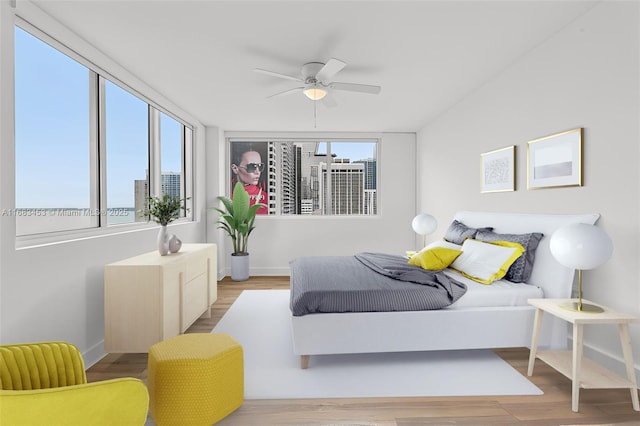 bedroom with light hardwood / wood-style flooring and ceiling fan