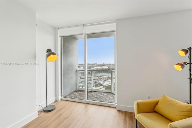 sitting room with hardwood / wood-style flooring