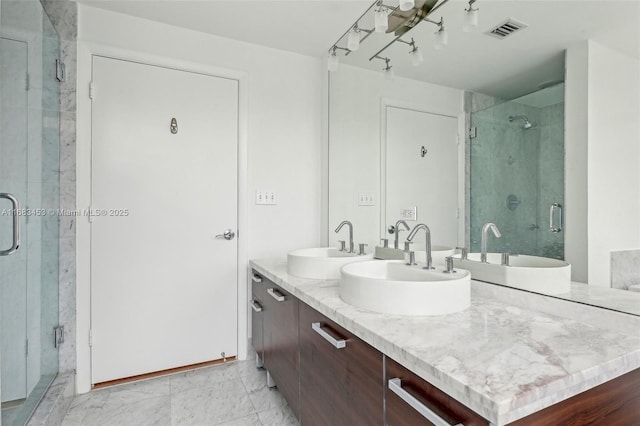 bathroom with an enclosed shower and vanity