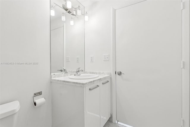 bathroom with toilet and vanity