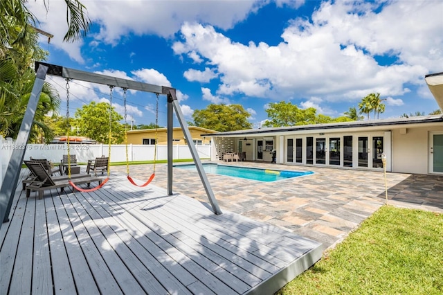 view of swimming pool with a deck