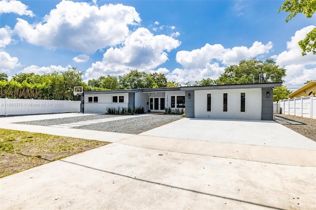 view of front of home with fence and driveway