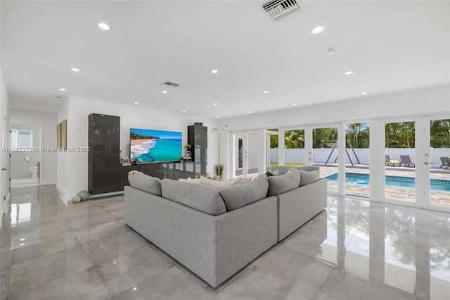 living area featuring recessed lighting, french doors, visible vents, and marble finish floor