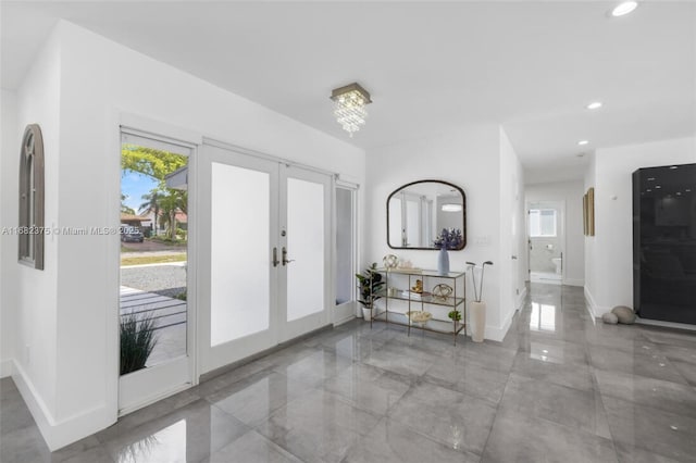 foyer with baseboards, french doors, and recessed lighting