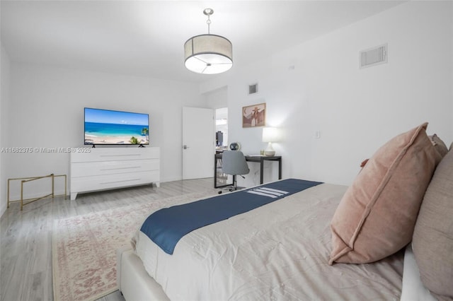 bedroom featuring light wood finished floors and visible vents